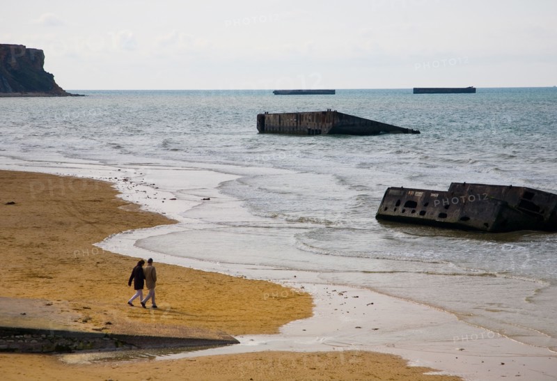 The Beach at Arromanches, Normandy with some of the remains of the Mulberry Harbour used in the 1944 Normandy Landings
