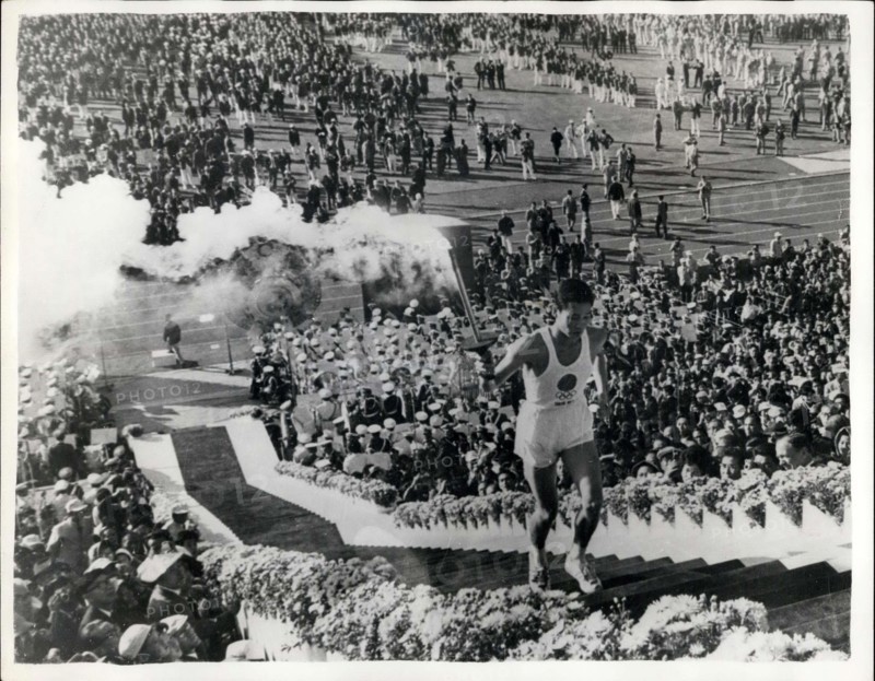 Oct. 11, 1964 - OPENING OF THE OLYMPIC GAMES IN TOKYO: The 1964 Olympic Games was officially opened yesterday in Tokyo when 7000 athletes from 94 nations marched in ceremonial parade, in the National Stadium. Photo Shows:- The impressive scene as Olympic Torch bearer, 19-year old Japanese student, Yoshinari Sakai, carries the torch up the long steps to the Olympic Flame - at yesterday's opening ceremony.