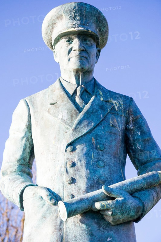 Close up, statue of Vice Admiral Ramsay on the cliff top at Dover castle.Standing with one hand in pocket and the other holding a telescope. Blue sky.