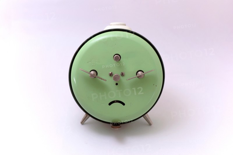An old Junghans mechanical alarm clock with a white background