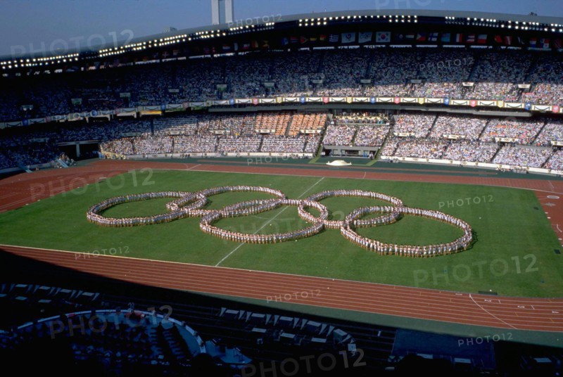 Seoul, Korea, 1988: Performers form the interlocking Olympic rings before a packed stadium audience during the opening ceremonies at the summer Olympic Games. ©Bob Daemmrich