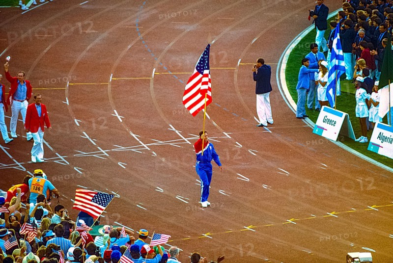 Ed Burke Team USA flag bearer marches in the opening ceremonies at the 1984 Oympic Summer Games.