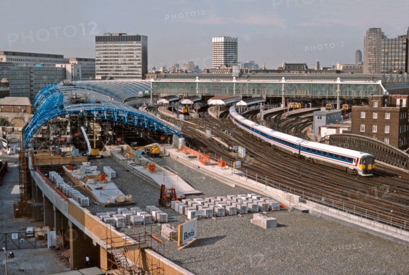 A Network SouthEast Class 442 Wessex electric departs London Waterloo and passes the ongoing construction work for the four new platforms to accommodate the soon to be introduced Eurostar trains. Once completed these new platforms would form Waterloo International railway station which opened on the 14th November 1994. 28th July 1992.