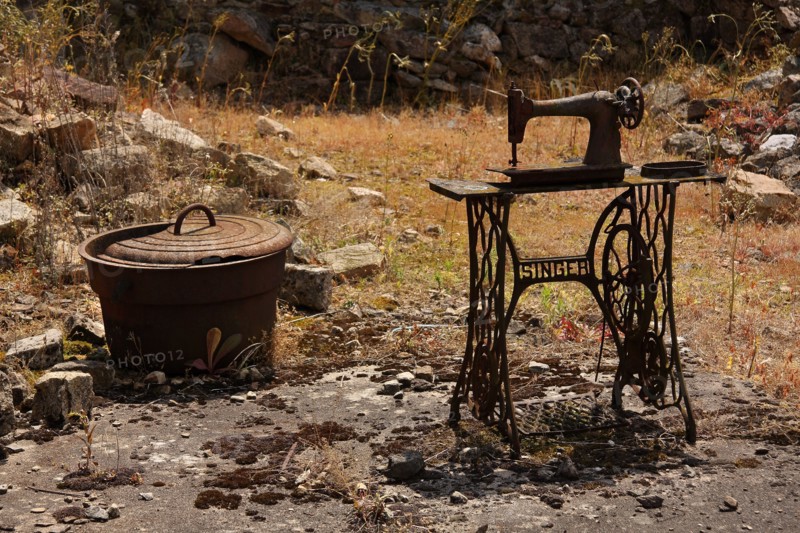 The remains of a Singer sowing machine and a cooking pot in the martyred village of Oradour sur Glane Limousin France
