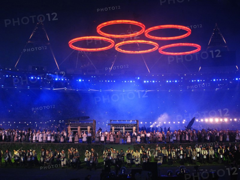 Some of the cast for the final rehearsal for the opening ceremony of the 30th Olympic Games under Olympic Rings