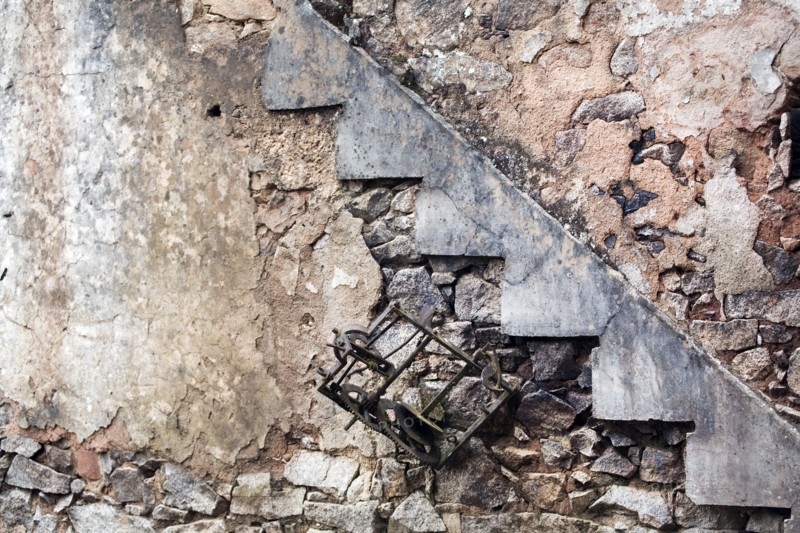 Destroyed the French village Oradour-sur-Glane. Interior with ruins of a clock and stair case.