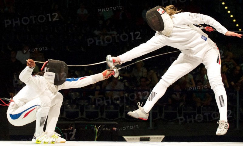 The German epee fencer Britta Heidemann (R) fights against against Laura Flessel-Colovic from France during the European Fencing Championship in Leipzig, Germany, 21 July 2010. France won the team competition against the German team at 45-35 hits and came in third place. Photo: Peter Endig