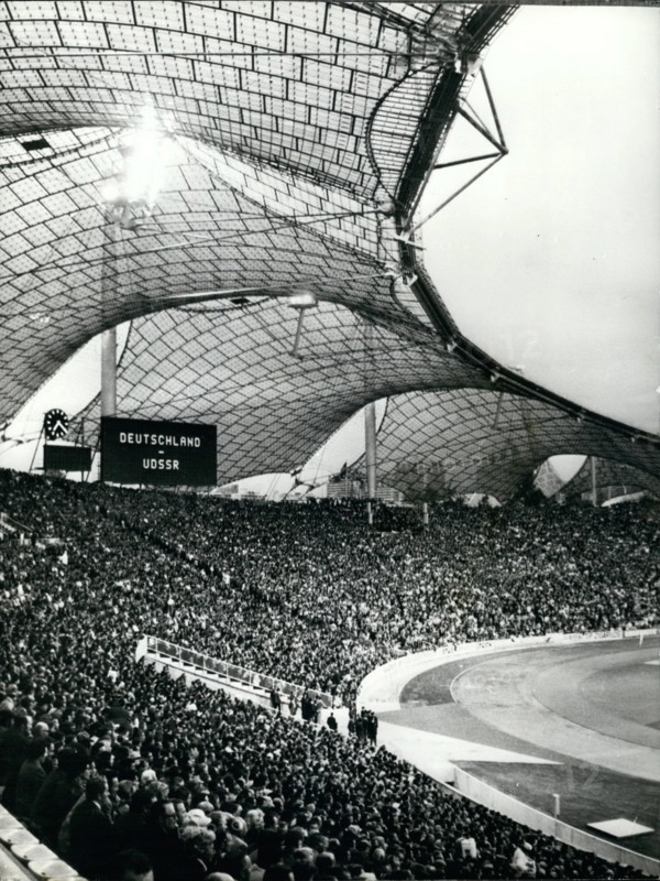 May 05, 1972 - 80,000 pack the Olympic stadium - for soccer match: The Olympic Stadium was formally opened with a soccer match between West Germany and the Soviet Union, providing the first ''acid test'' for the Stadium and traffic constables of Munich - and prior to the August opening of the Olympic Games. Photo shows part of the 80,000 crowd which attending the soccer match in the Olympic Stadium in Munich.