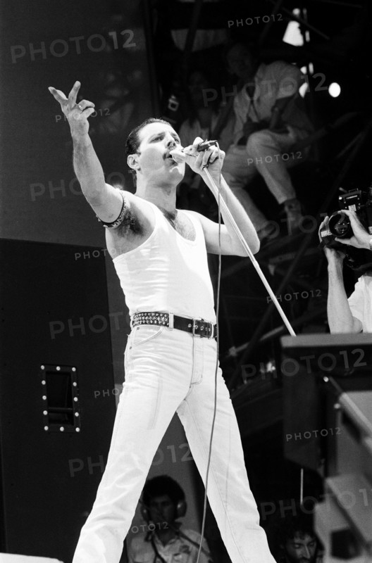 Freddie Mercury, lead singer of British rock group Queen, performing on stage at Wembley Stadium during the Live Aid concert. 13th July 1985.