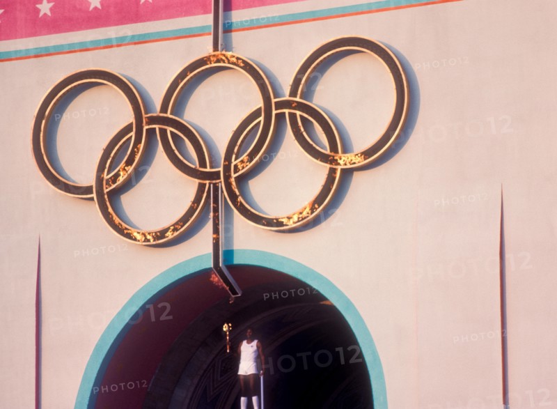 Rafer Johnson brings Olympic torch to light flame during opening ceremonies at 1984 Olympic Games in Los Angeles.
