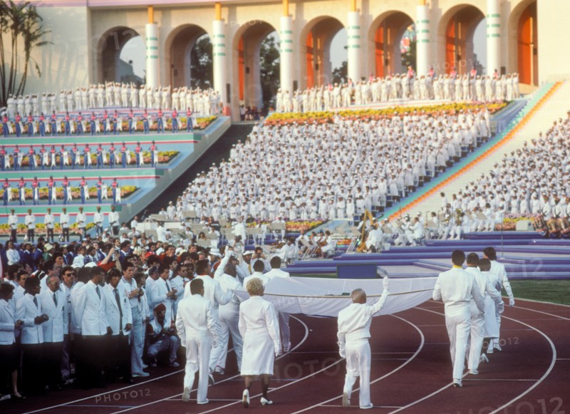 Olympic medalists carry and escort the Olympic flag in the Opening Ceremonies of the 1984 Olympic Games in Los Angeles.