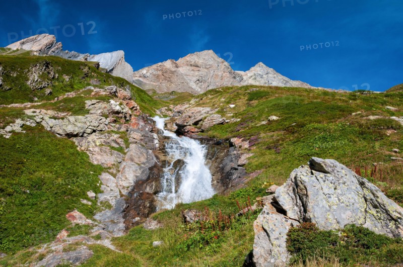 Alpine waterfall on the GR Tour du Mont-Blanc trail to the Robert Blanc refuge, Savoie (73), Auvergne-Rhone-Alpes, France