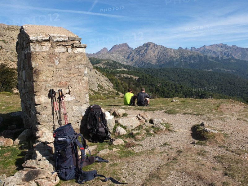 GR20 trekkers taking a rest at Col de St Pierre between Castel de Vergio and Lac de Nino, Corsica, France
