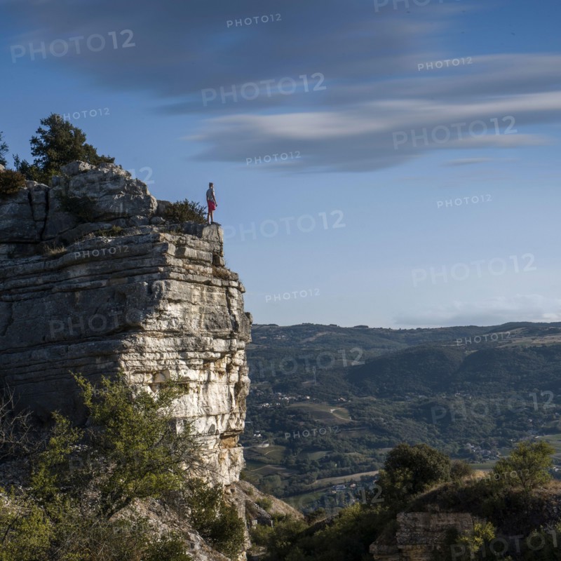 Men standing on top of a cliff