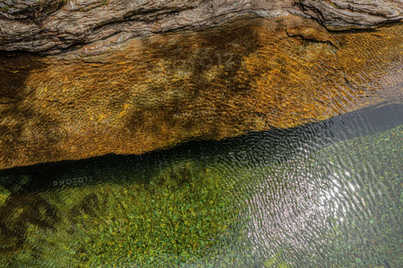 Top view of the water of a river and a rock bank. The wind gives the whole a superb texture. On the GR 70, Robert Louis Stevenson Trail, Cevennes, Fra
