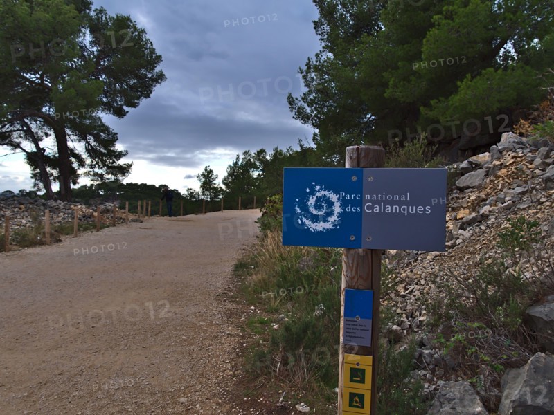 Blue signpost at the entrance of Calanques National Park (Parc National des Calanques) near Cassis at the French Riviera. Focus on sign.