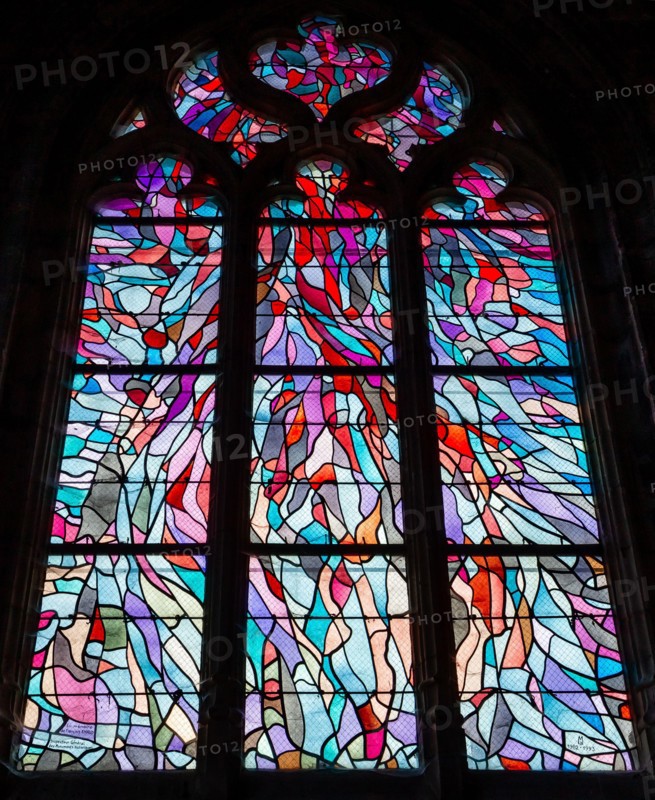 ABBEVILLE, SOMME, FRANCE, JUNE 18, 2023 :  details of stained glasses windows in Saint Sepulcre church, by Alfred Manessier workshop, year 1989  to 19