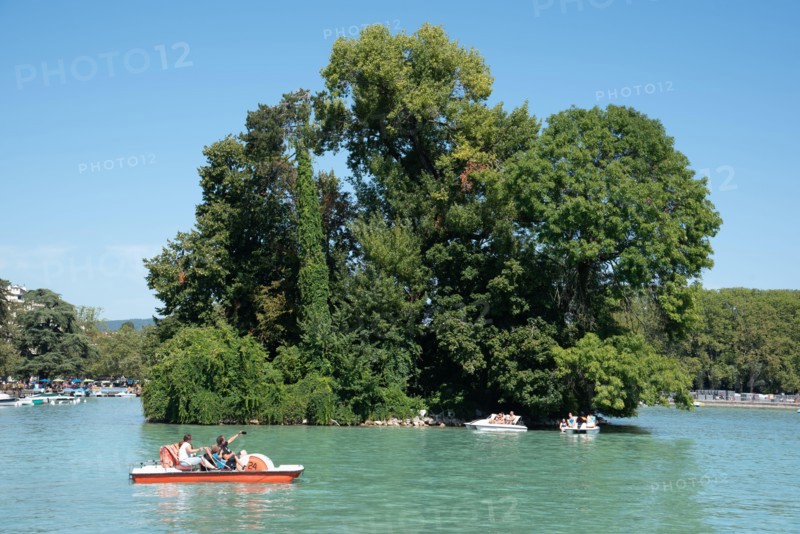 Tourists on Pedalo, Pedal Boat or Paddle Boat & Île des Cygnes, or Swan Island, Annecy Lake or Lac d'Annecy Haute-Savoie France