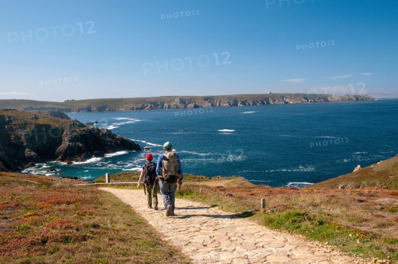 Hikers at Pointe du Van near Saint-They chapel, Trepasses bay and Iroise sea, Cleden-Cap-Sizun, Finistere (29), Brittany, France