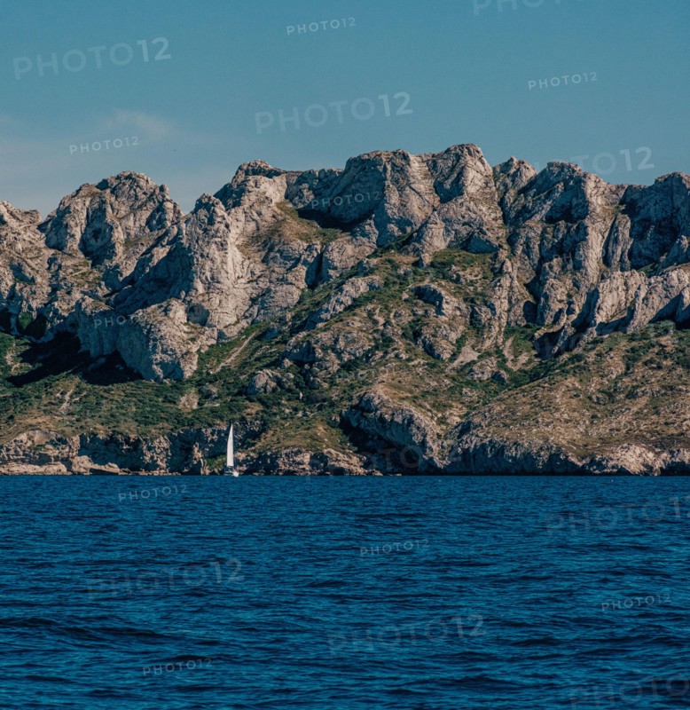 Steep rocky cliffs above a serene sea in The Calanques, Marseille
