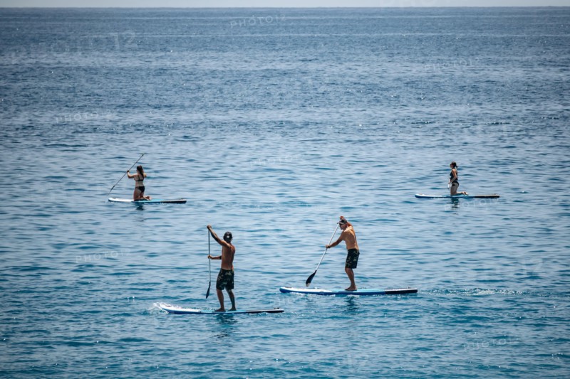 Nice, France - May 25, 2024: People paddling in the Mediterranean Sea near Nice