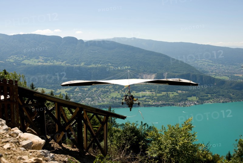 hang glider taking off from a ramp at the col de la forclaz above lake annecy haute savoie france