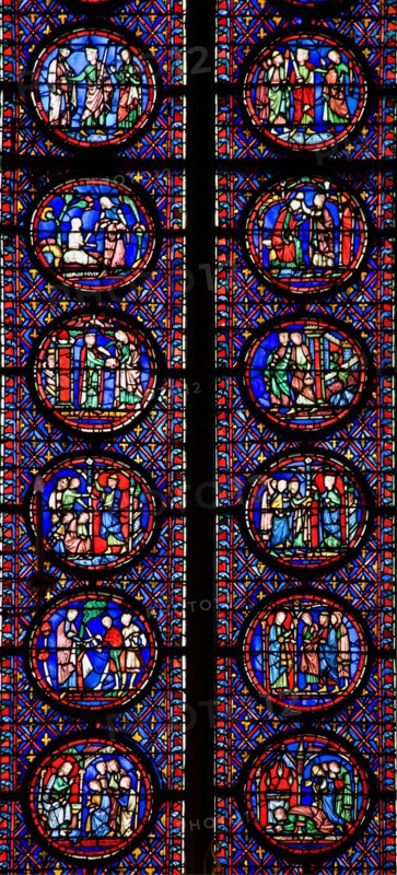 Interior of Sainte-Chapelle showing detail of medieval stained glass window panels Paris France Europe EU