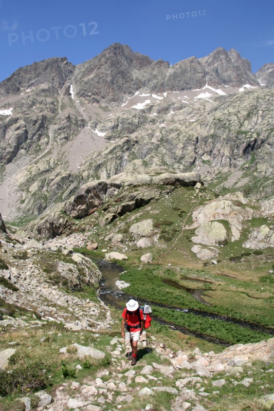 Walker climbing above Valle de la Fous in the French Mercantour national Park, Alpes Maritimes