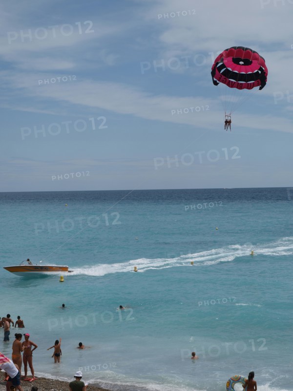 Paragliding by Nice beach, South of France, Mediterranean.  Boat, Parachute, Sun, tourism.