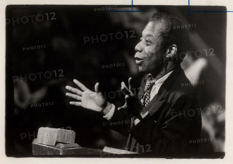 (Cropped mug published T, 05/04/1979, B-8) Author James Baldwin speaking about American racism to a predominantly black audience at UCSD on 05/03/1979.