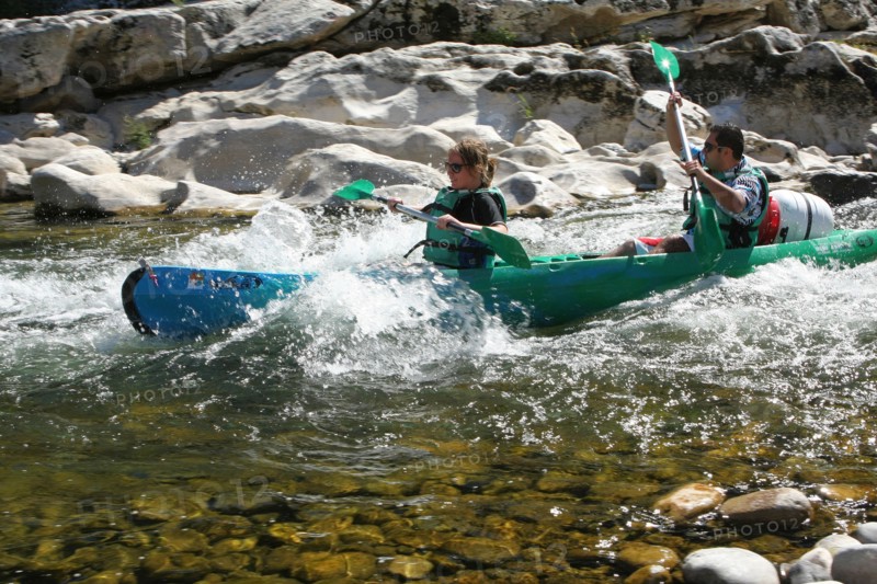 Canoeists in rapids on the River Ardeche, France.