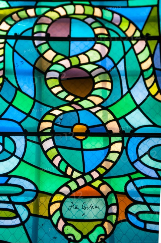 Colorful stained glass windows done by Jean Cocteau in a chapel in Metz, France