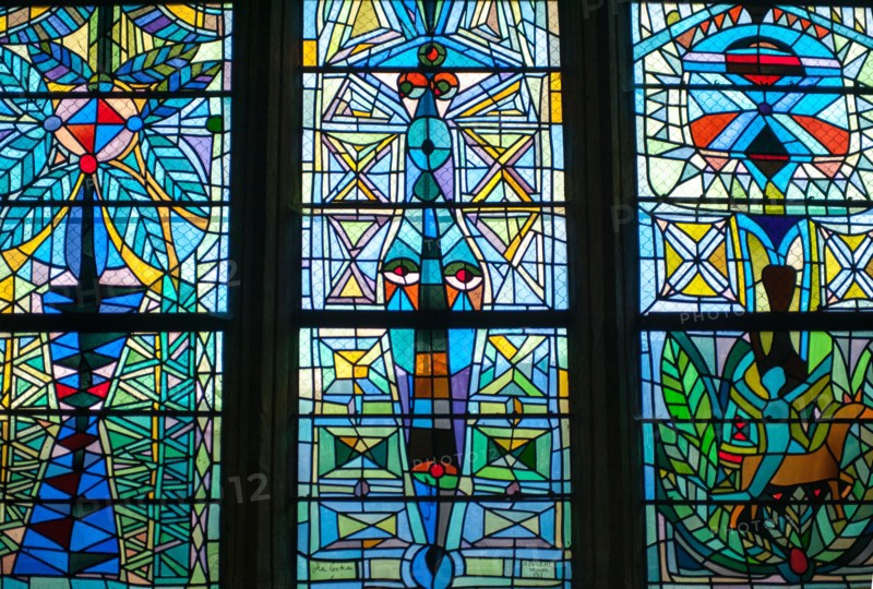 Colorful stained glass windows done by Jean Cocteau in a chapel in Metz, France