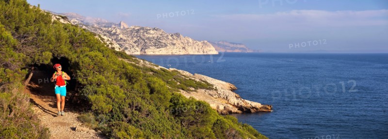 female wanderer walking on footpath along the rocky coast, France, Provence, Calanques National Park, Marseille Cassis La Ciotat