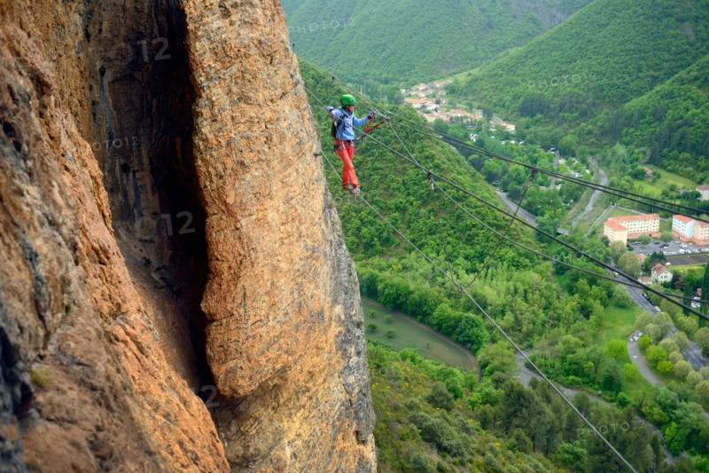 climber on a simple suspension bridge in the rock face, Via ferrata du Rocher de Neuf Heures, France, Provence, Digne-les-Bains