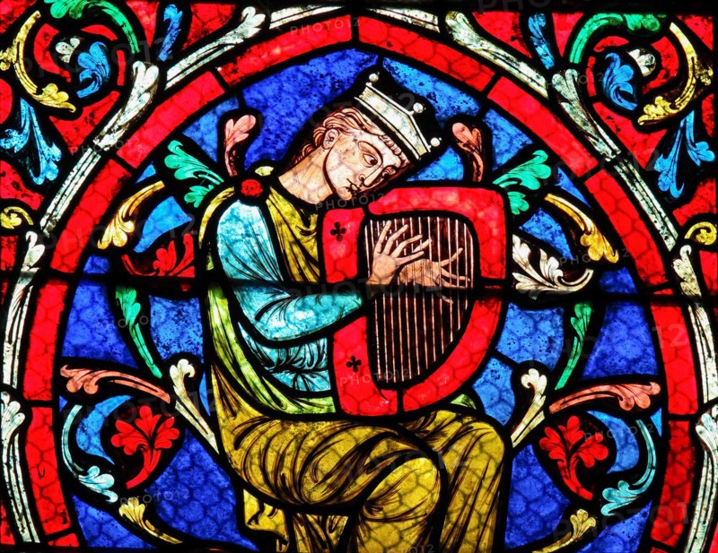 Stained glass window in the Notre Dame Cathedral in Paris, depicting King David playing on his Harp.
