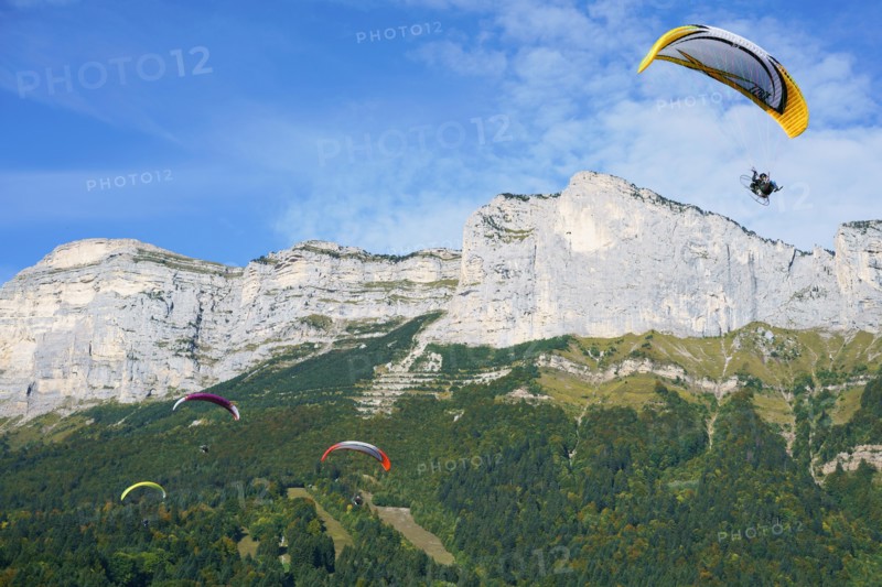 Four paramotors flying at the 2017 Coupe Icare event. Saint-Hilaire du Touvet, Isère, Auvergne-Rhône-Alpes, France.