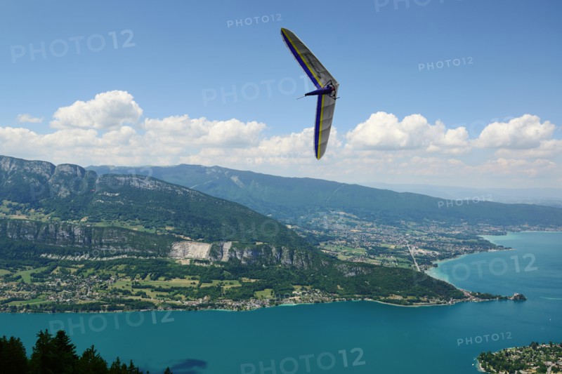 2014-06-25 Annecy; France. Hang glider pilot do extreme aerobatic maneuvers over lake Annecy. Popular place for airborne sports.