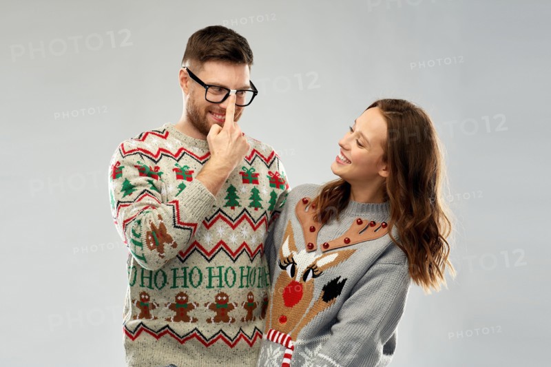 happy couple at christmas ugly sweater party