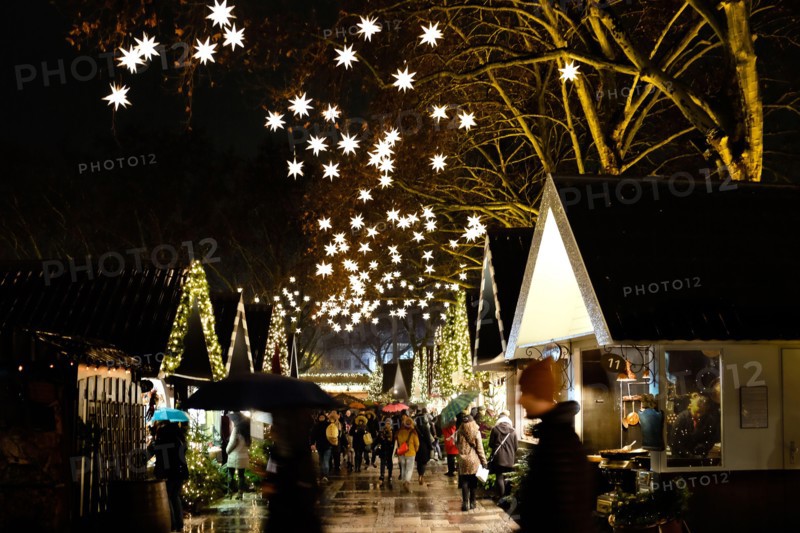 German Christmas market at night  with market stalls and illuminated stars