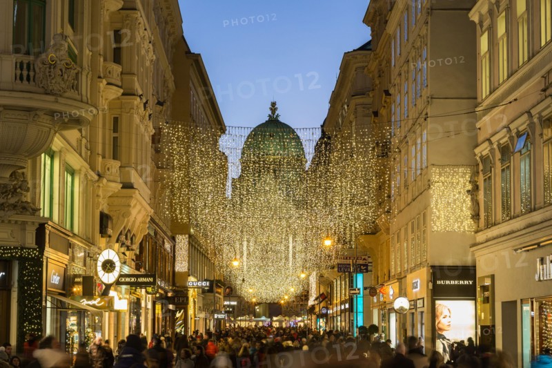 VIENNA, AUSTRIA - 2ND DECEMBER 2016: A view along Kohlmarkt in Vienna at Christmas. Lots of people, decorations and the outside of shops can be seen.