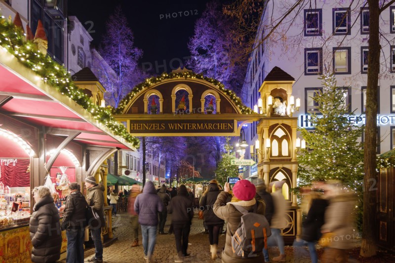 Night scenery, beautiful arched entrance of Weihnachtsmarkt, Christmas Market in Köln, at Alter Markt, famous marketplace nearby Cologne city hall.