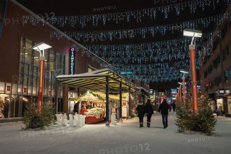 A street in Rovaniemi city with New Year and Christmas decorations, Finland, Lapland. Christmas market, blue New Year's illumination.