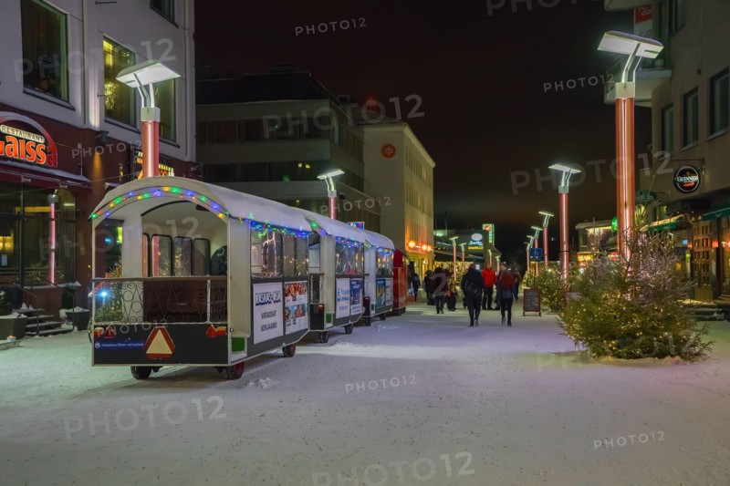 A street in Rovaniemi city with New Year and Christmas decorations in winter, Finland, Lapland. Christmas trees, ?hristmas express, New Year's illumin
