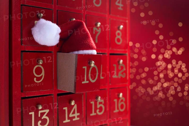 Red wooden Advent calendar with surprise for Christmas