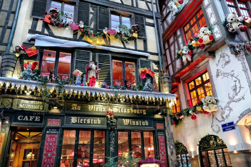 France, Alsace, Bas-Rhin, Strasbourg, Christmas market, by the streets, decorated facade.