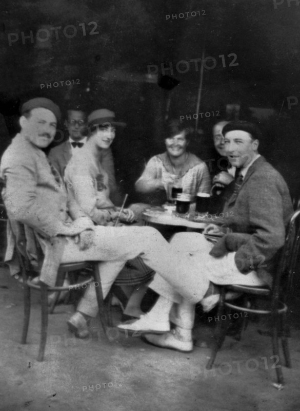 PAMPLONA, SPAIN - July 1925 - Ernest Hemingway with Lady Duff Twysden, Hadley Hemingway, and three unidentified people at a cafe in Pamplona, Spain, d