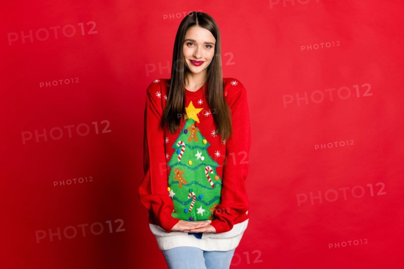 Photo of cute lovely young woman good mood wear ugly christmas sweater isolated on red color background