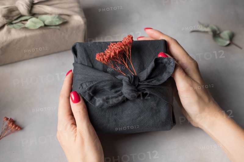 Female hands holding Furoshiki gift