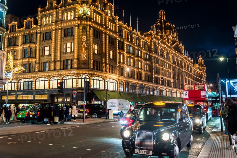 Harrods, a Luxury Department Store and busy traffic on Knightsbridge at Christmas time, London, England, UK